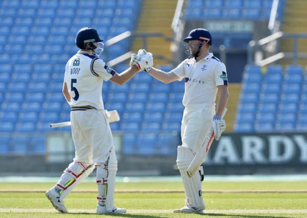 Joe Root and Jonny Bairstow celebrate their record breaking partnership for 
Yorkshire against Surrey in May. (Picture: Bruce Rollinson)