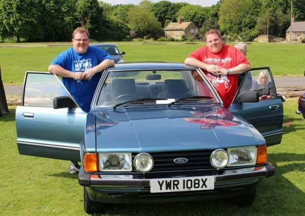 Dynamic duo: Twins Richard and Christopher Barker with their dads restored Ford Cortina.