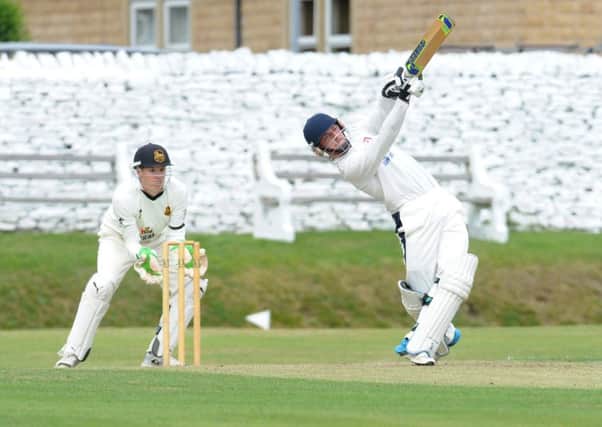 Joe Greaves hits a  boundry, one of six fours and six sixes on his way to a century (104) for Pudsey Congs, but neighbours St Lawrence won by six wickets. PIC: Steve Riding