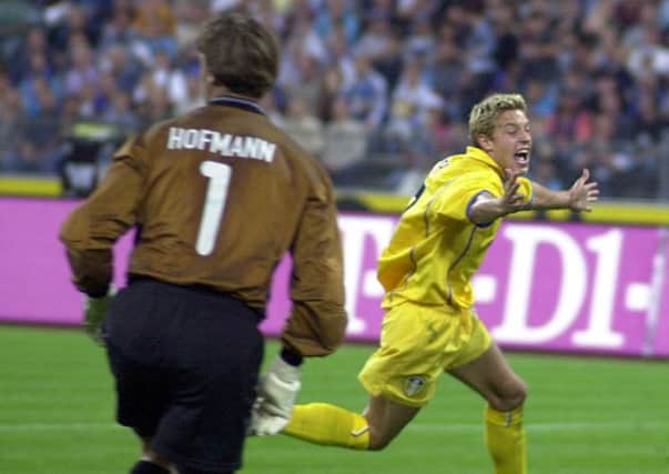 Alan Smith celebrates scoring against TSV 1860 Munich in 2000.