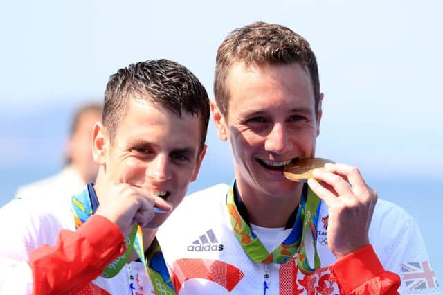 Great Britain's Alistair and Jonny Brownlee with their Gold and Silver medals