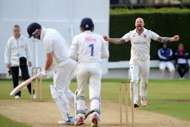 Cleckheaton's Sam Wilson celebrates getting the wicket of Hanging Heaton's Nick Connolly. Pictures: Steve Riding.