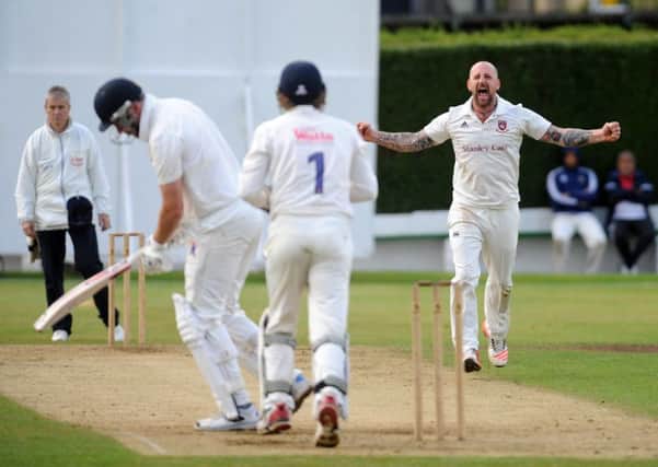 Cleckheaton's Sam Wilson celebrates getting the wicket of Hanging Heaton's Nick Connolly. Pictures: Steve Riding.