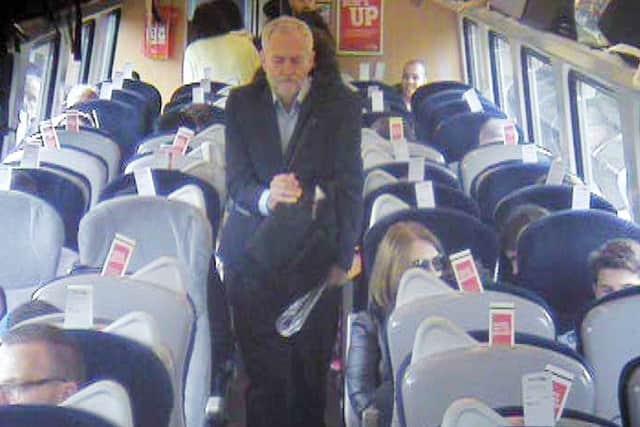 Handout  CCTV footage dated 11/08/16 issued by Virgin Trains which was filmed at 11.08am, approximately 8 min after departure from King's Cross in central London, showing Labour Party leaderJeremy Corbyn, walking past several empty, unreserved seats in Coach F, after a video emerged last week which showed Mr Corbyn sitting on the floor, reading a newspaper, and saying "This is a problem that many passengers face every day" before calling for public ownership of the railways.  Picture: Virgin Trains/PA Wire