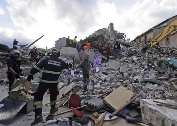 Rescuers search for survivors through the rubble of collapsed buildings following an earthquake, in Amatrice, Italy. Picture: Alessandra Tarantino.