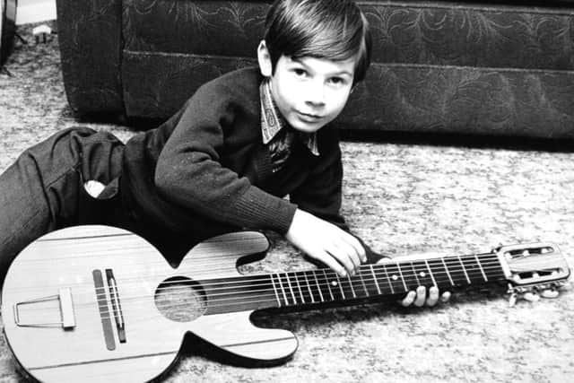 Harrogate.  28th January 1973

WHEN the headmaster of his school suggested that pupils might be given guitar lessons, Christopher Riley, nine, decided to make his own.

"I was amazed when he produced one and I was even more amazed when it actually made a sound like a guitar," said Christopher's father, Mr. George Riley, of Dale Close, Hampsthwaite, near Harrogate.

Christopher is seen in this Yorkshire Post picture with the instrument, made of wood which he found in his father's garage.

"It was some veneered wood left over from a porch I've been building," said Mr. Riley.

"Christopher drew out the shape and took it round to a neighbour, Mr Maurice Fuguill, of Dale Close, for some help.  At first I thought it was just a little toy, but it has become much more."