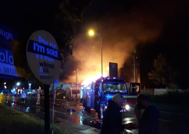 The fire rages at Mirfield Prestige in Huddersfield Road. Picture: David Smith.