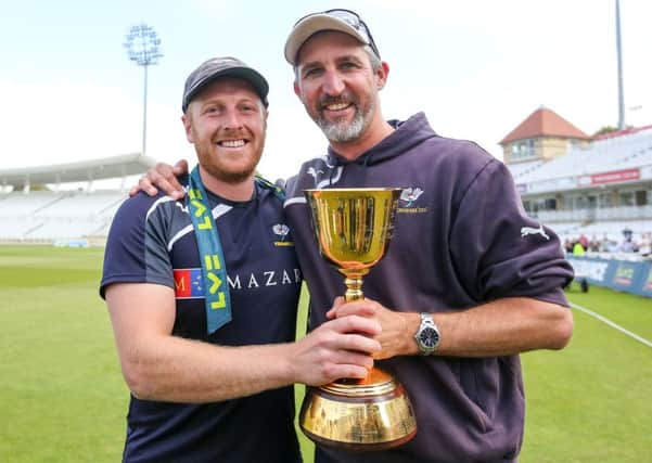 Yorkshire captain Andrew Gale and First Team Coach Jason Gillespie celebrate with the 2014 County Championship trophy. Picture by Alex Whitehead/SWpix.com