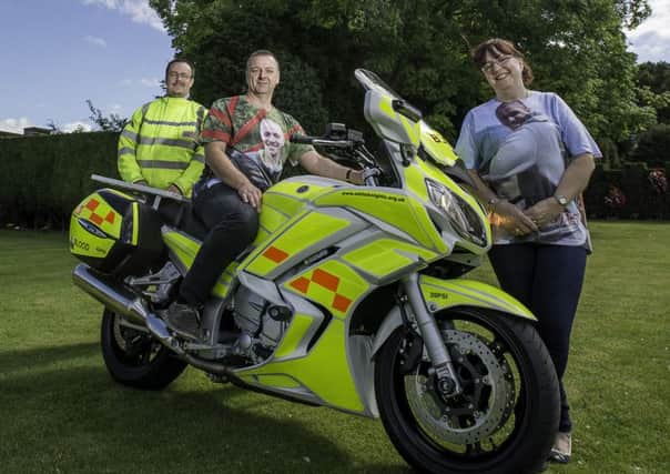 TRIBUTE: Andrew and Beverley Clark with the Whiteknights and the motorbike they have named after the Clarks son, Lewis.
