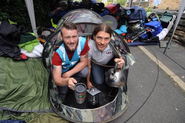 Haydn Lee and Brett Sutton with some of the tents and other camping gear collected from the site.