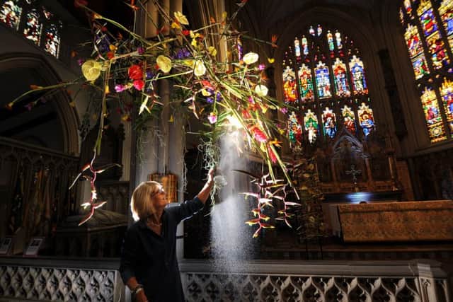 Leeds Minster celebrates 175 years with contemporary Floral designs.. Catherine Gledhill sprays her Floral Design in the Minster...1st September 2016 ..Picture by Simon Hulme