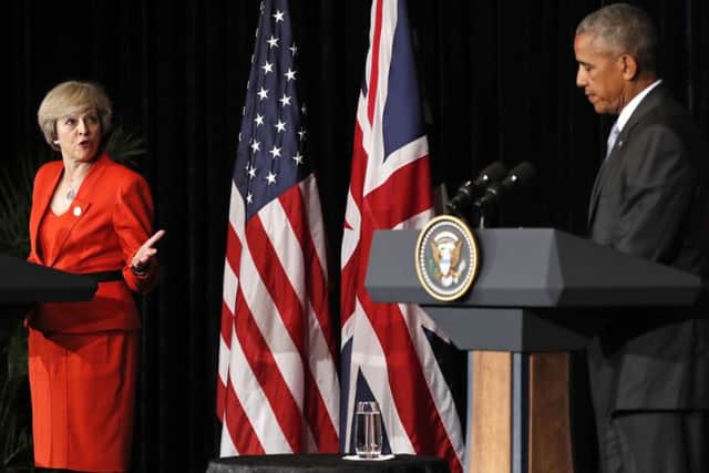U.S. President Barack Obama and British Prime Minister Theresa May talk to media after a bilateral meeting in Hangzhou in eastern China's Zhejiang province on Sunday.