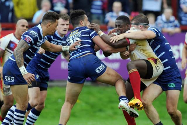 Josh Walters,  of Featherstone, tackles Batley's Alex Brown. PIC: Steve Riding