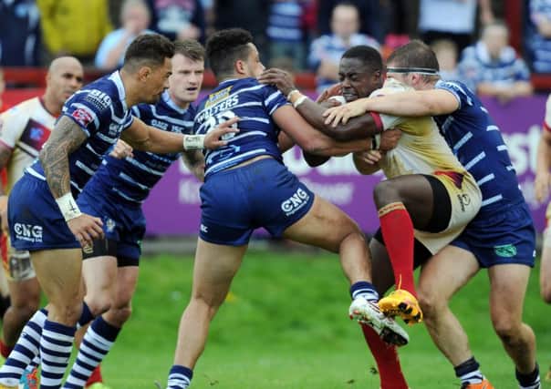 Josh Walters,  of Featherstone, tackles Batley's Alex Brown. PIC: Steve Riding