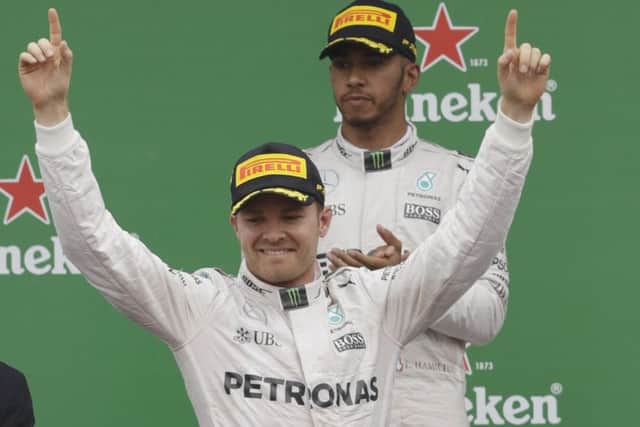 WELL DONE: Nico Rosberg of Germany, left, celebrates as secondplaced Mercedes teaam-mate Lewis Hamilton of Britain applauds Picture: AP Photo/Luca Bruno.