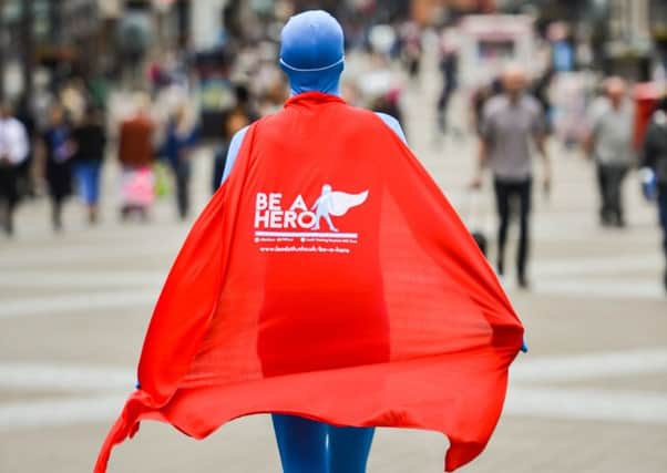 The Be A Hero mascot walks down Briggate, Leeds.