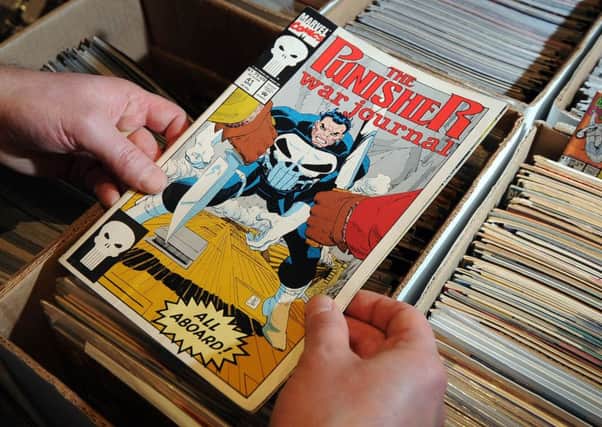 Date:21st March 2015. Picture James Hardisty, (JH1007/74a) Collectorabilia event held at the Marriott Hotel, Leeds. Pictured A visitor looking at one of the many comic books on sale.