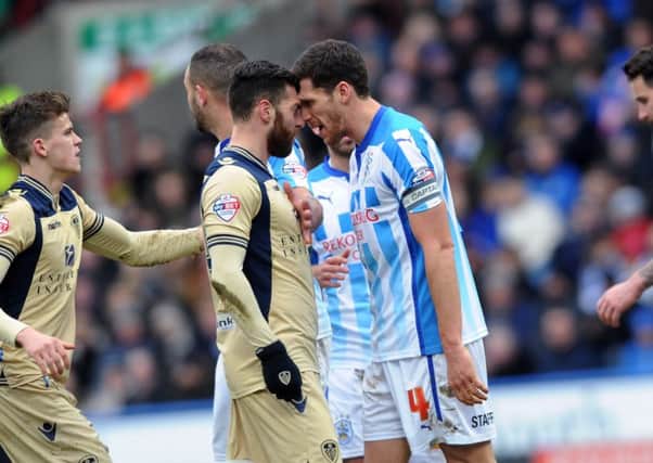 UP CLOSE AND PERSONAL: 
Leeds United's Mirco Antenucci and Huddersfield's Mark Hudson clash in January 2015.
 Picture: Jonathan Gawthorpe.