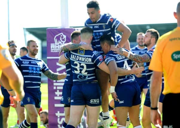 Featherstone players celebrate after Jordan Baldwinson goes over the first try, after which Salford took charge. PIC : Jonathan Gawthorpe