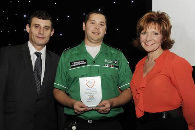 Last year's winner Steven Hudson receives his Emergency Response Worker of the Year award from Anthony Lynch, of Rainbow Windows, and BBC presenter Clare Frisby.
 Picture by Bruce Rollinson.