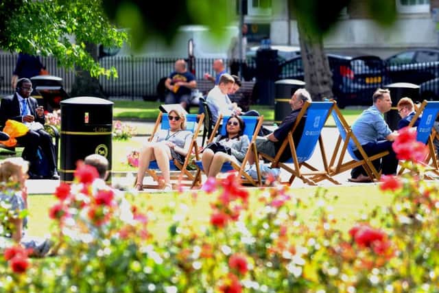 People enjoy the sunshine at Park Square, Leeds