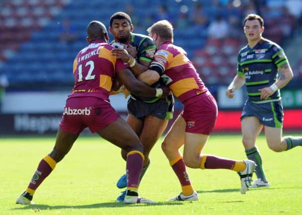 Kallum Watkins is tackled by Michael Lawrence and Ryan Hinchcliffe.