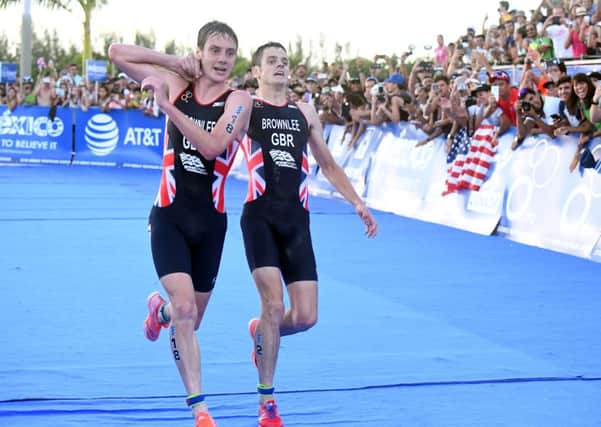 Leeds's own Alistair Brownlee (left) helps his brother Jonny to get to the finish line.