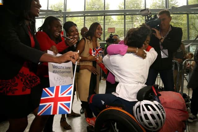 Kadeena Cox is greeted by family as she arrives back at Heathrow Airport