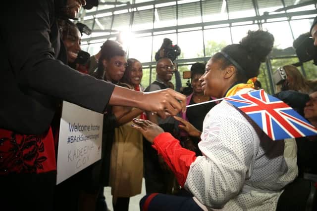 Kadeena Cox is greeted by family as she arrives back at Heathrow Airport