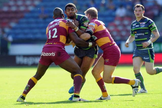 EVER-PRESENT: Leeds 
Rhinos' Kallum Watkins tackled by Huddersfield Giants' Michael Lawrence and Ryan Hinchcliffe.  Picture: Tony Johnson.