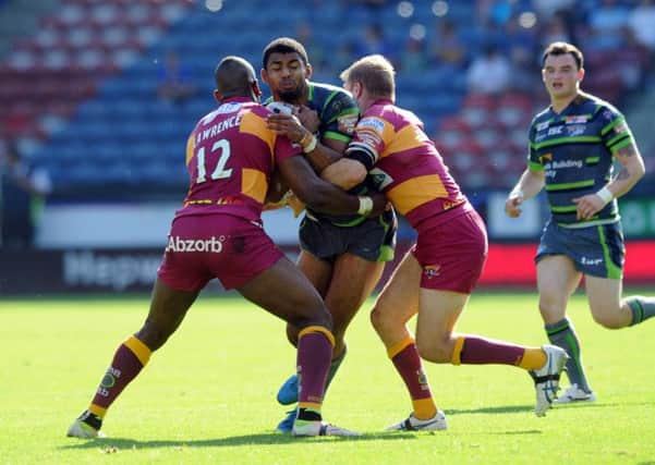 EVER-PRESENT: Leeds 
Rhinos' Kallum Watkins tackled by Huddersfield Giants' Michael Lawrence and Ryan Hinchcliffe.  Picture: Tony Johnson.