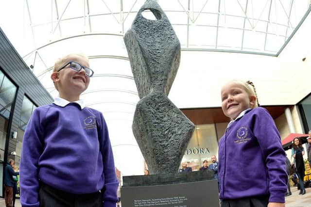 A famous Hepworth sculpture has moved to a new home just yards away from where the renowned sculptor was born. Pictured are Dexter Grice (6) and Amelia Grice (4) at Barbara Hepworths sculpture Ascending Form (Gloria) at Trinity Walk shopping centre, in Wakefield.
