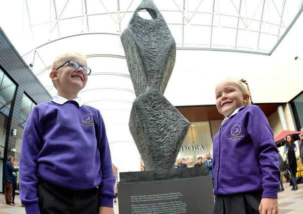 A famous Hepworth sculpture has moved to a new home just yards away from where the renowned sculptor was born. Pictured are Dexter Grice (6) and Amelia Grice (4) at Barbara Hepworths sculpture Ascending Form (Gloria) at Trinity Walk shopping centre, in Wakefield.