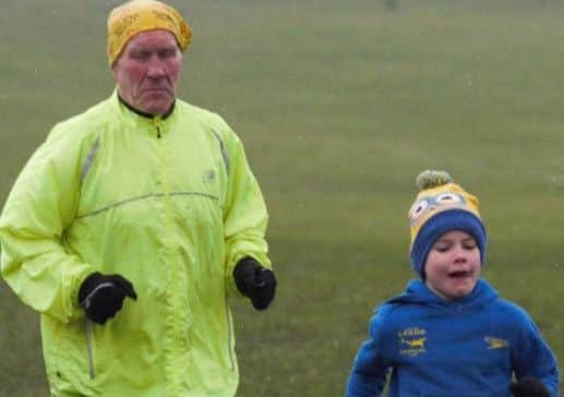 Mr Wood running with his grandson Ewan, seven.