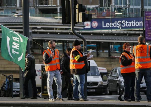 Members of the RMT union picket at Leeds Station. PIC: PA