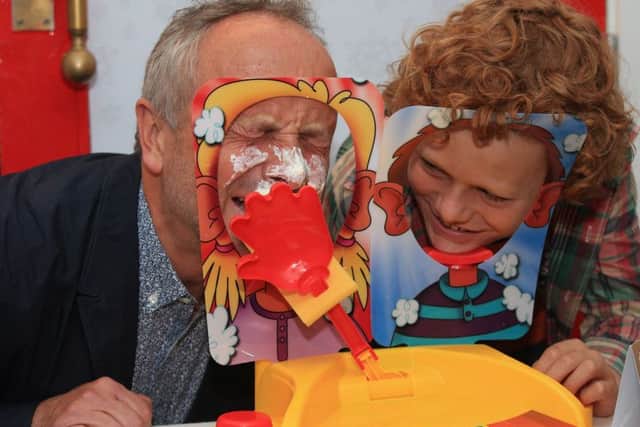 Alan Twigg (left) plays Pie Face Showdown with his son Archie, 11. PIC: PA