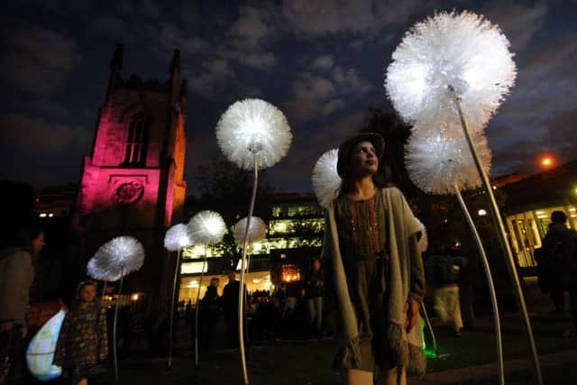 Leeds Light Night: Gracie Murray, aged eight from Oakwood, looks at the dandelions lights at Merrion Gardens.  Pictures: Simon Hulme.