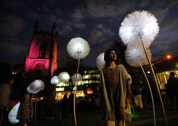 Leeds Light Night: Gracie Murray, aged eight from Oakwood, looks at the dandelions lights at Merrion Gardens.  Pictures: Simon Hulme.