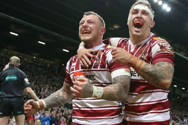 Wigan Warriors Josh Charnley (left) celebrates his try against Warrington Wolves with Sam Powelll.
