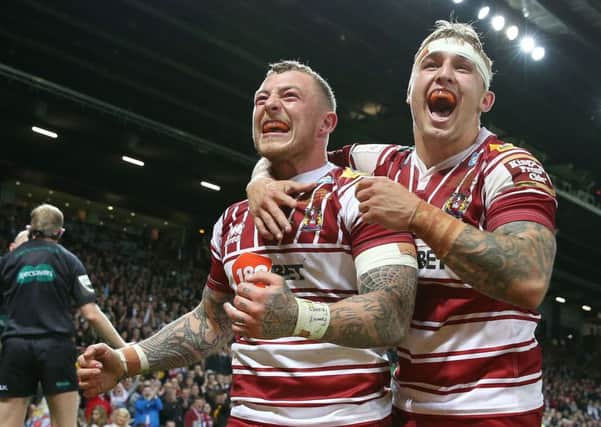 Wigan Warriors Josh Charnley (left) celebrates his try against Warrington Wolves with Sam Powelll.