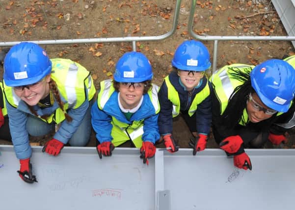 121016   Pupils at Roundhay School  sign the girder before it is lifted into place on  The Pavilion at Roundhay School in Leeds as part of the 'topping out' ceremony.