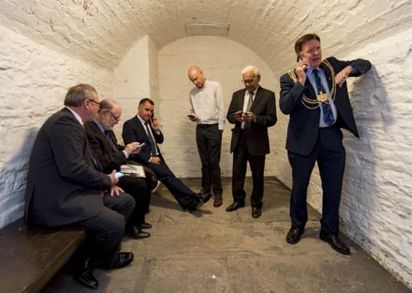 SUPER SIX: The Lord Mayor of Leeds, right, and his five accomplices make calls for charity in the cell. PIC: James Hardisty