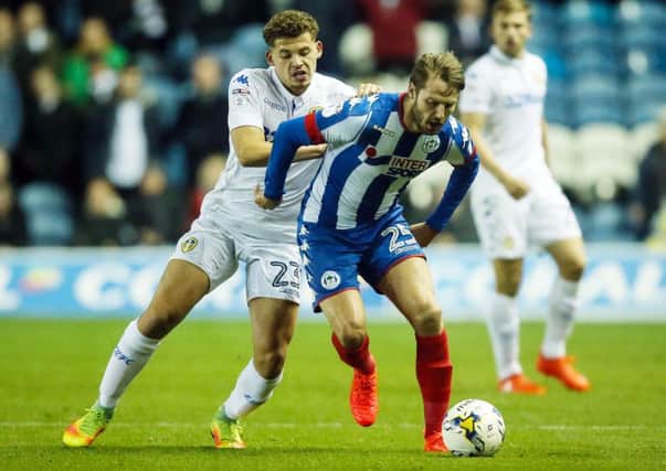 Kalvin Phillips and Wigan Athletic's Nick Powell battle for the ball. PIC: PA