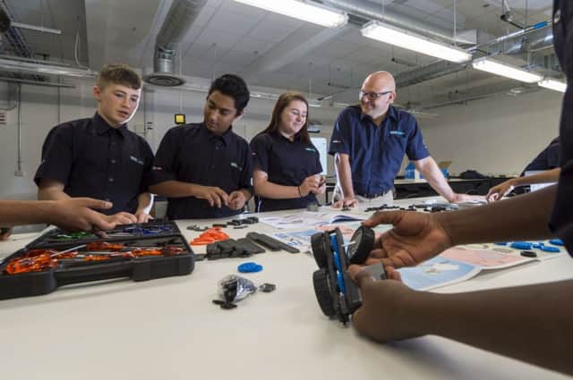 Principal of University Techinical College Mark Kennedy, watching year 10 Mechatronic students build robots. Pic James Hardisty.