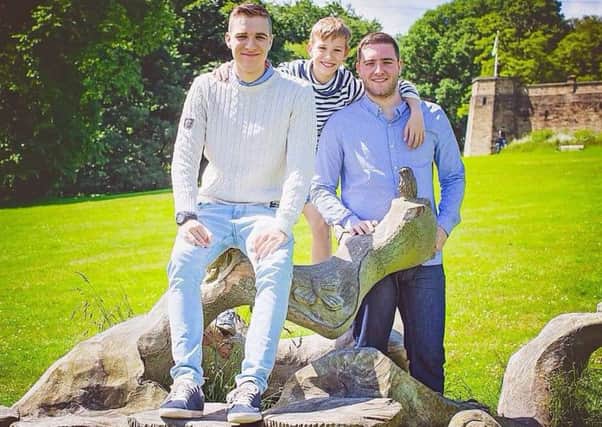 Dominic Moore with his brothers, Joshua and Charlie.
