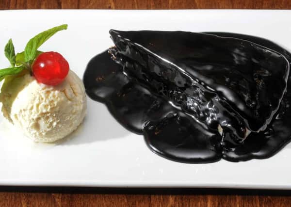 Steamed rice cake stuffed with toffee topped with chocolate sauce and served with vanila ice cream.