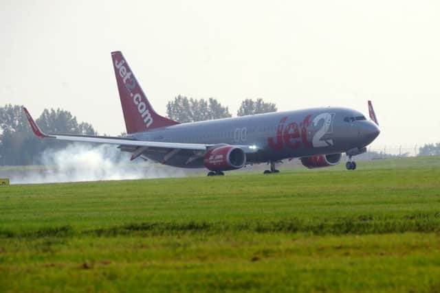 A plane lands at Leeds Bradford Airport.