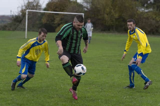 Horsforth Fairweather's Scott Robinson controls the ball under pressure from Danny McKane and John Ward, of Main Line Social. PIC: James Hardisty