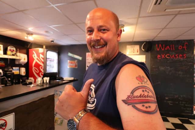 Tony Virr loves Huckleberry's restaurants so much that he's had its logo tattooed on his arm.