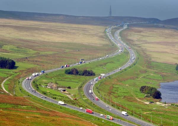 The M62 in West Yorkshire as it splits past Stott Hall Farm, and snakes up Moss Moor over the Pennines. PIC: Tony Johnson